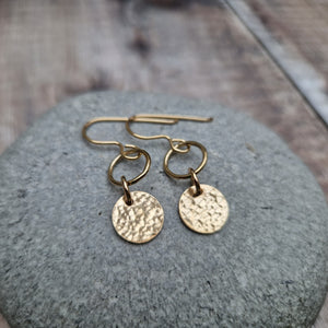 Gold hammered disc and circle drop earrings. Each earring has one gold filled open circle attached to gold earring wire. Dropping from the open circle is a gold-filled disc with hammered texture, measuring approximately 10mm diameter. Total drop from earlobe approximately 30mm providing lots of movement.