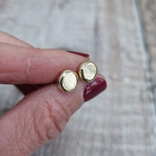 Load image into Gallery viewer, 9ct gold pebble shape stud earrings. Recycled 9ct gold melted into a smooth, imperfect round pebble shape with small imperfections on the surface of the gold to provide subtle interest. Each pebble shape measuring approximately 8mm x 7mm, mounted on gold earring bar.