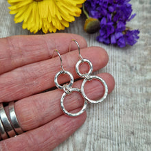 Load image into Gallery viewer, Sterling Silver two circle drop earrings. Each earring has one smaller silver open circle attached to silver earring wire. Dropping from the first open circle via two small silver hoops is a larger silver open circle. Each circle has slightly hammered texture, the largest circle measuring approximately 15mm diameter. Total drop from earlobe approximately 35mm providing lots of movement.