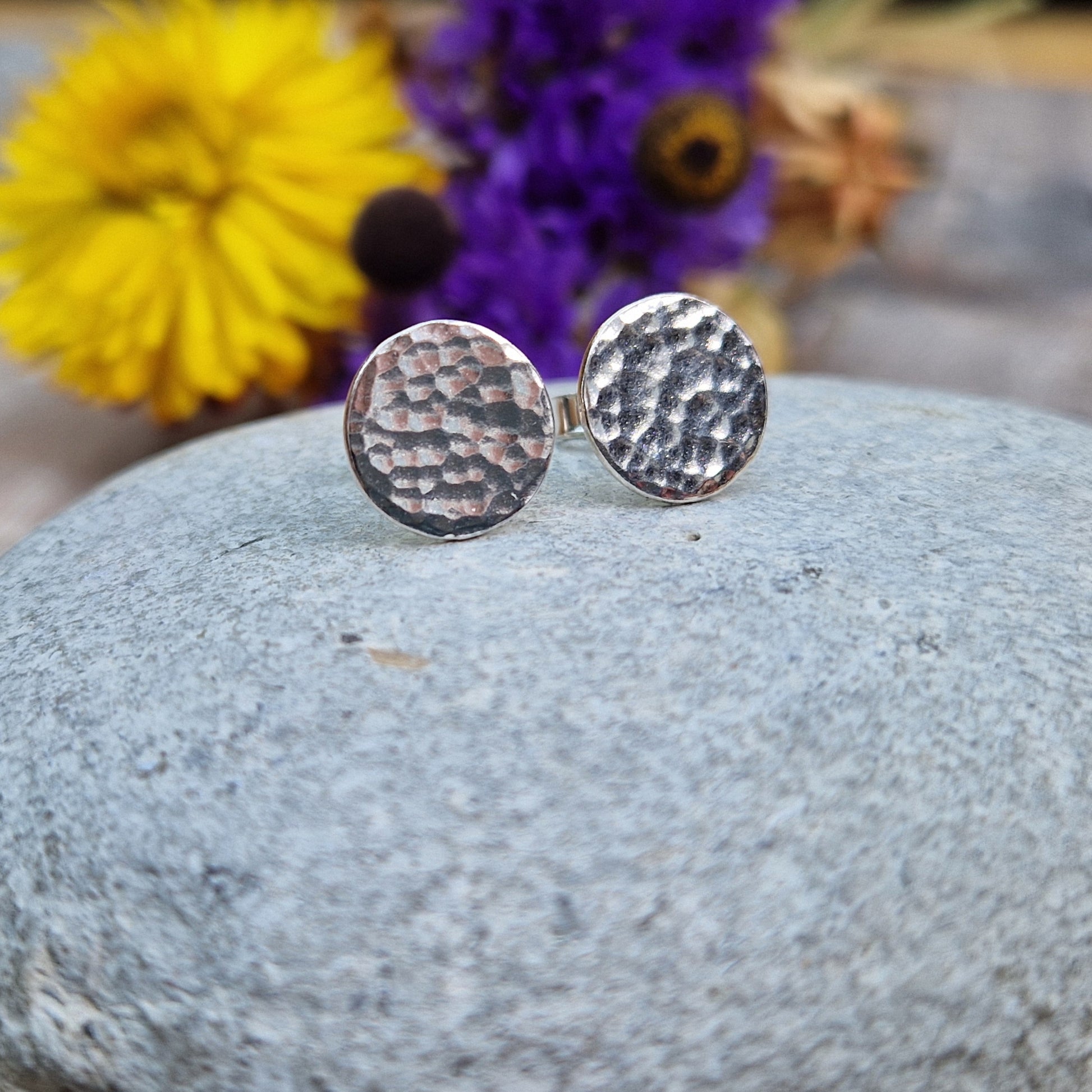 Each earring is a Sterling Silver flat disc with hammered texture mounted onto a stud bar.
