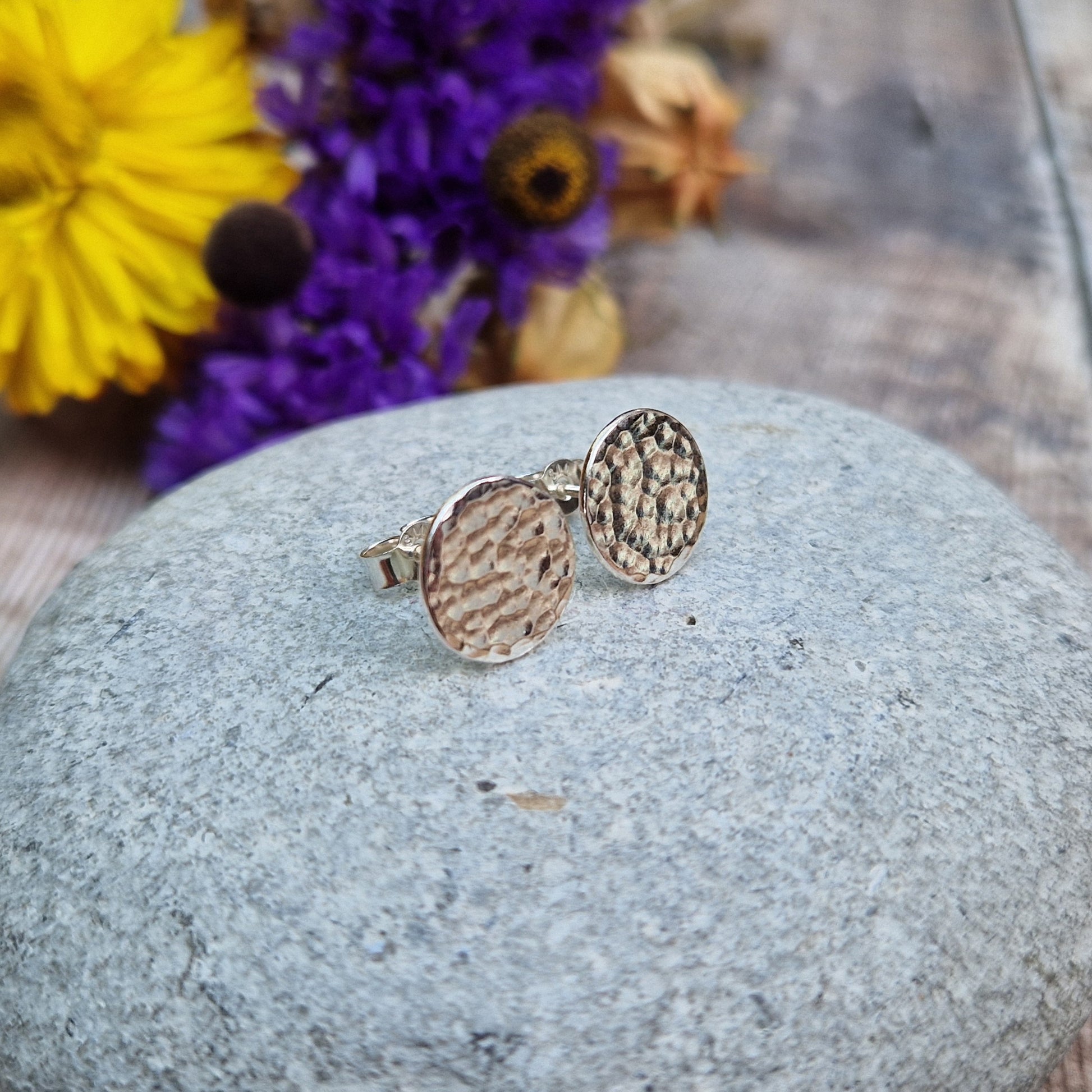 Each earring is a Sterling Silver flat disc with hammered texture mounted onto a stud bar.