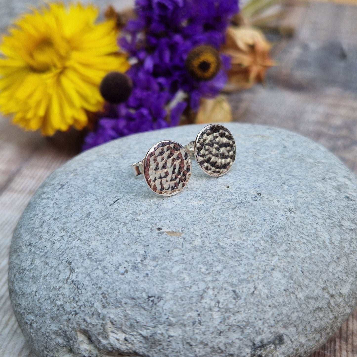 Each earring is a Sterling Silver flat disc with hammered texture mounted onto a stud bar.