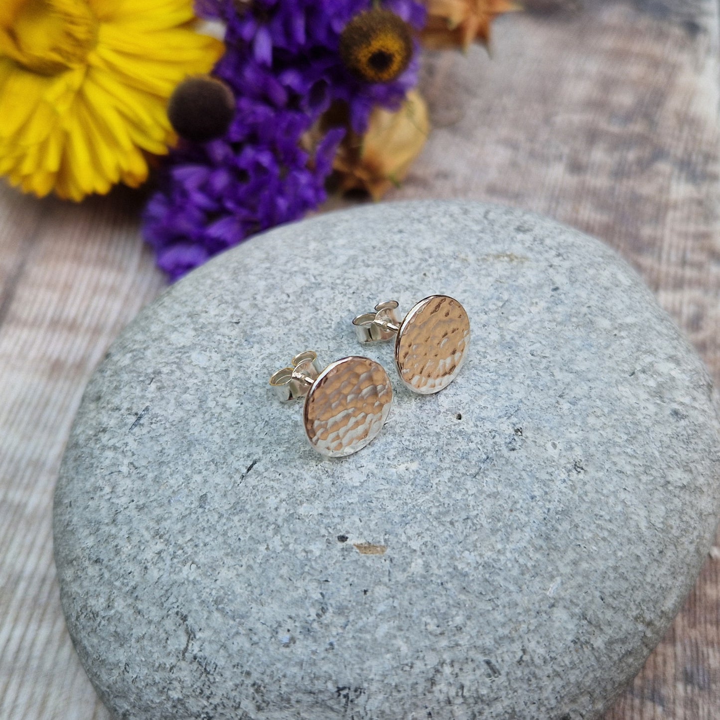 Each earring is a Sterling Silver flat disc with hammered texture mounted onto a stud bar.