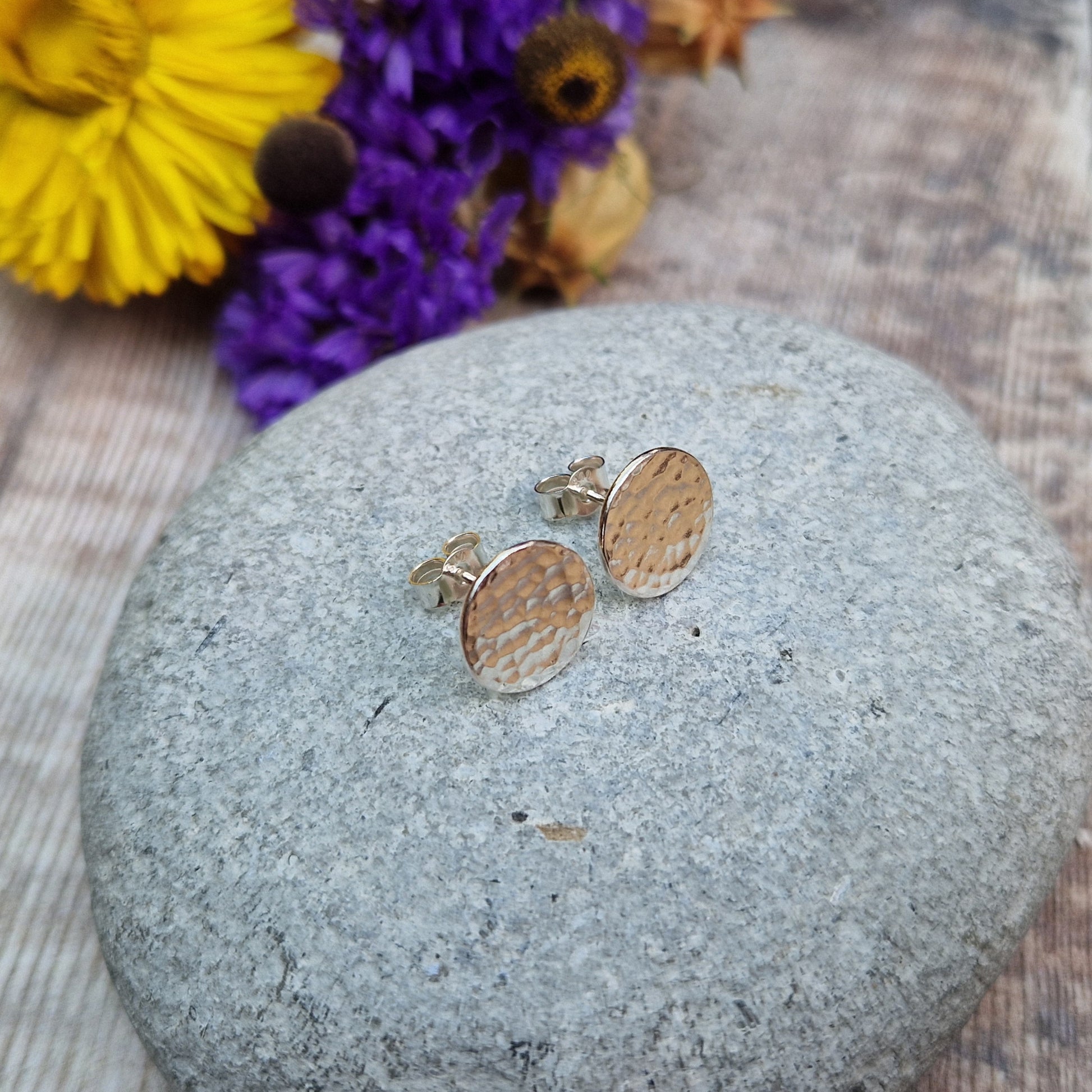 Each earring is a Sterling Silver flat disc with hammered texture mounted onto a stud bar.