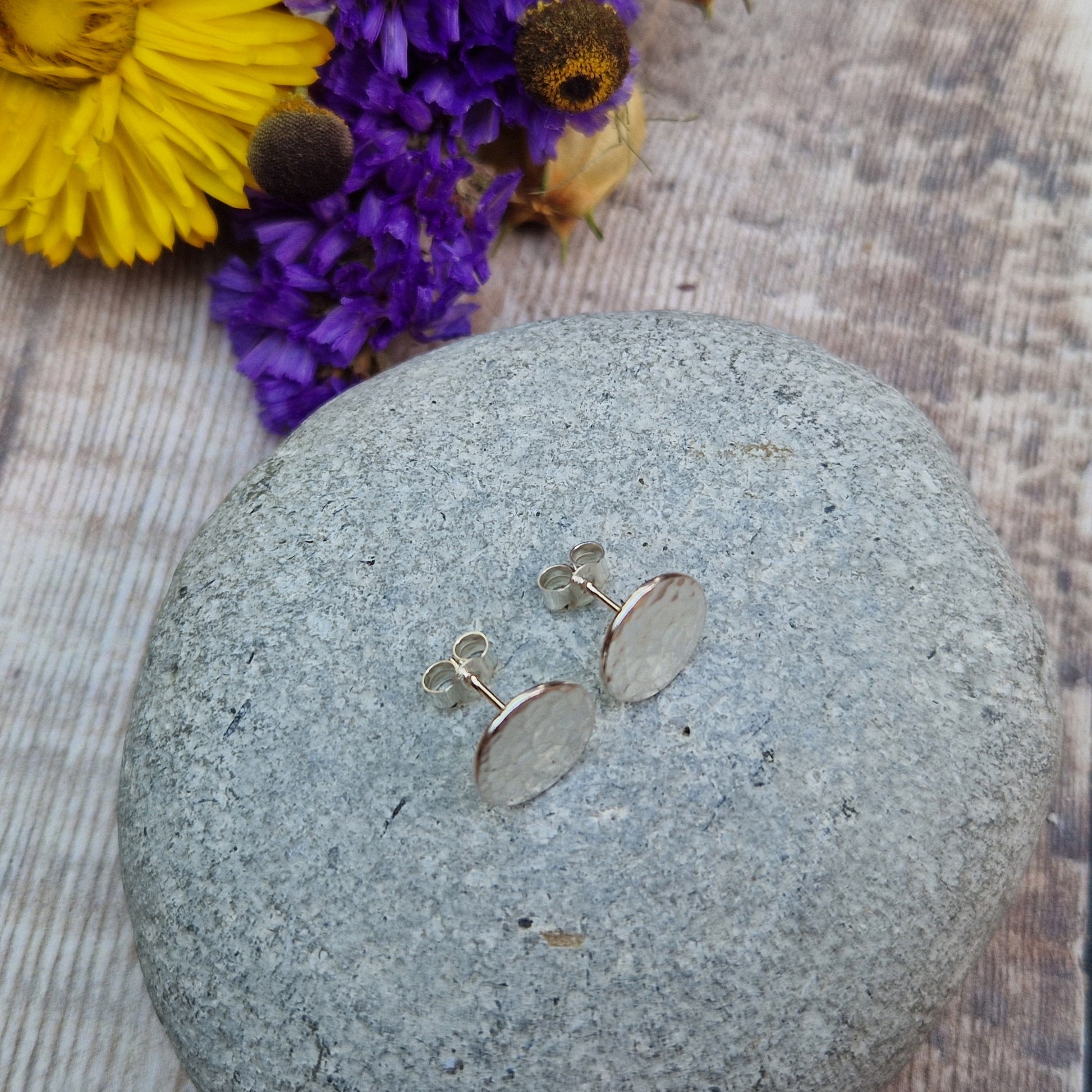 Each earring is a Sterling Silver flat disc with hammered texture mounted onto a stud bar.