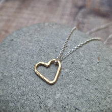 Load image into Gallery viewer, Open heart shaped 9ct gold pendant hangs from sterling silver chain necklace. Heart measures approximately 15mm diameter. Slightly hammered texture on the pendant.