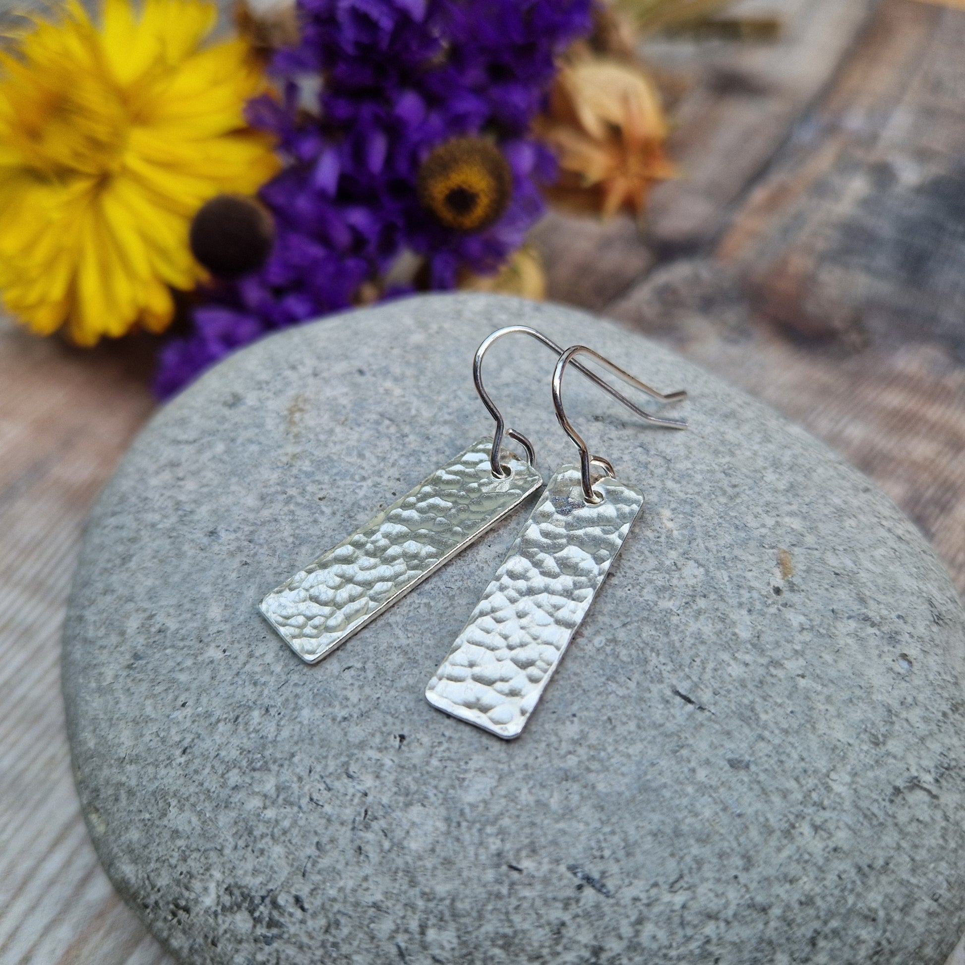 Each earring is a silver rectangle with hammered texture finish suspended from a silver earring wire.
