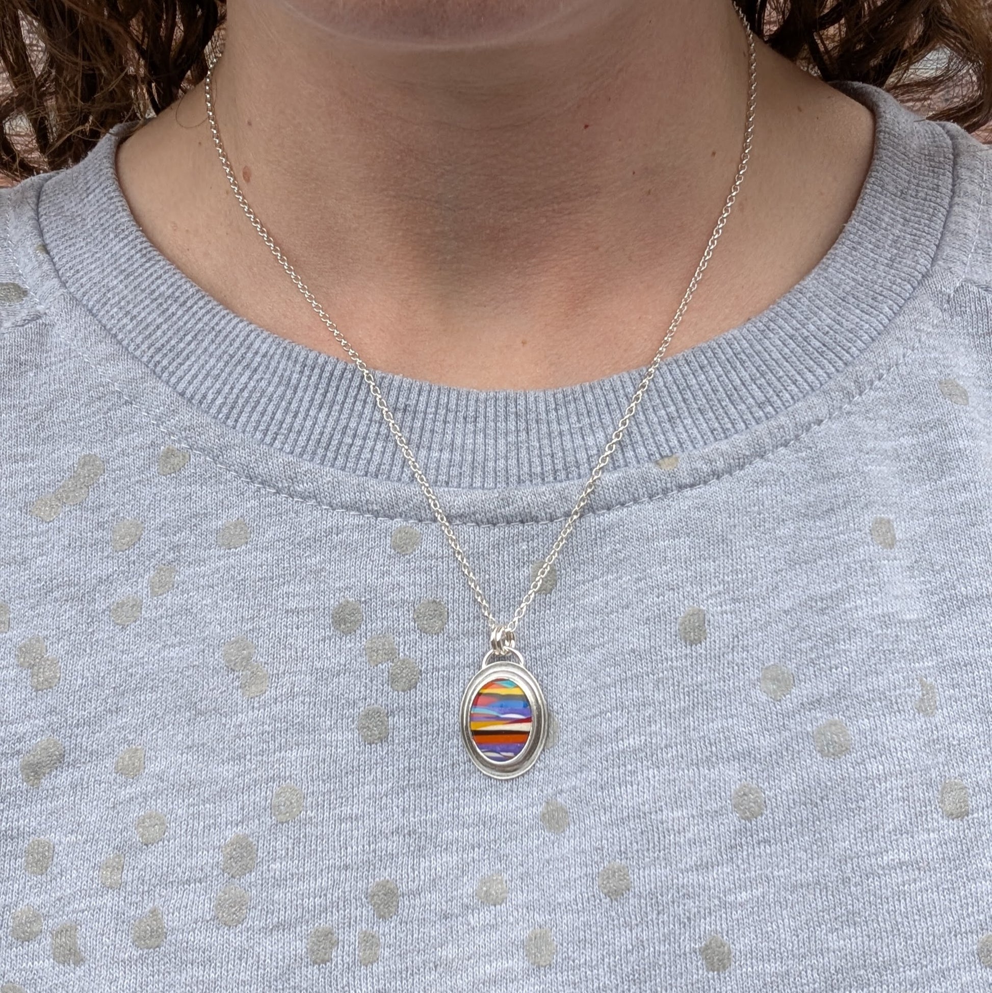 Surfite necklace worn around the neck, showing the 18-inch chain length and how the pendant sits when worn.