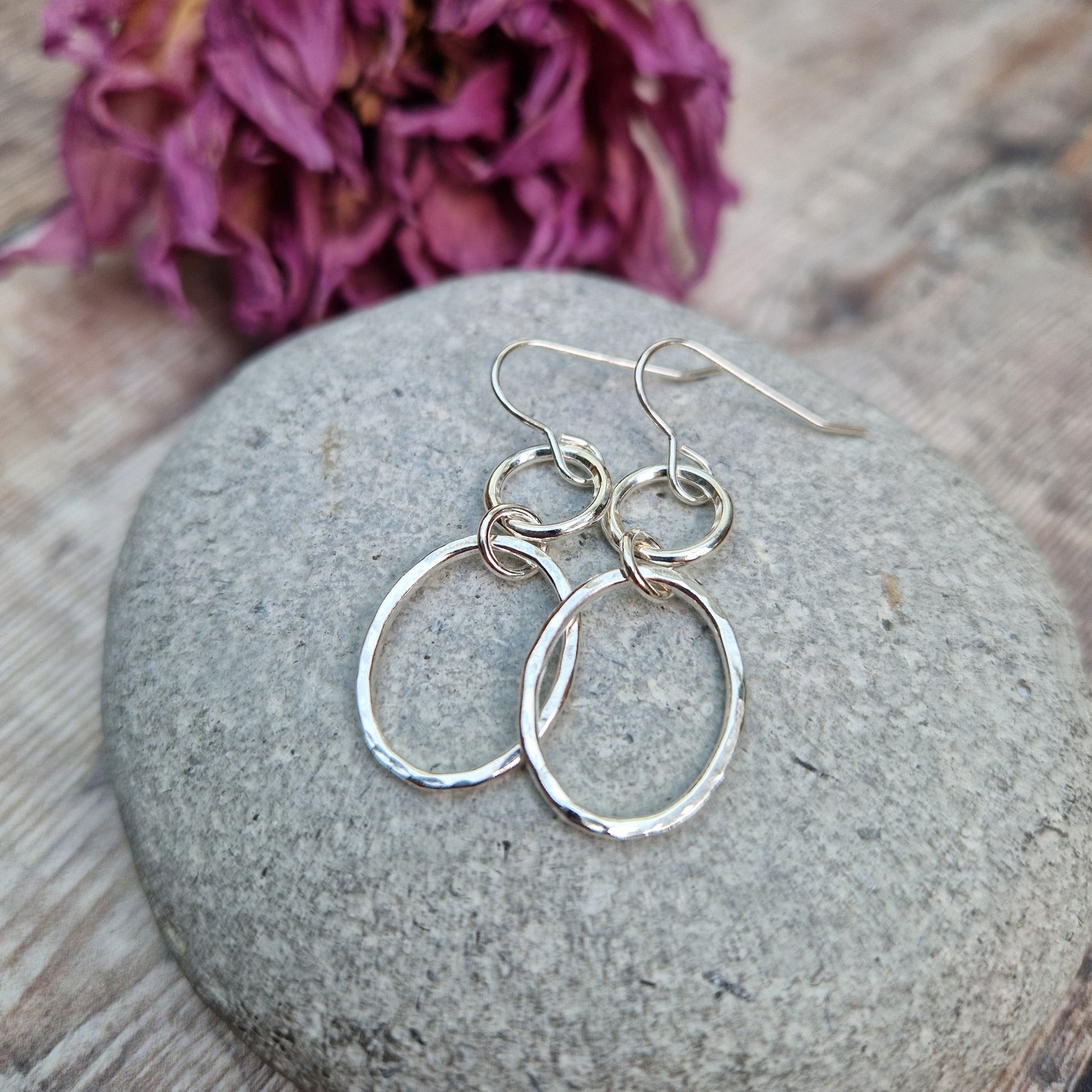 Each earring has one Sterling Silver open circle suspended from silver earring wire. A hammered texture silver open oval hangs from the open circle via a small circle link.