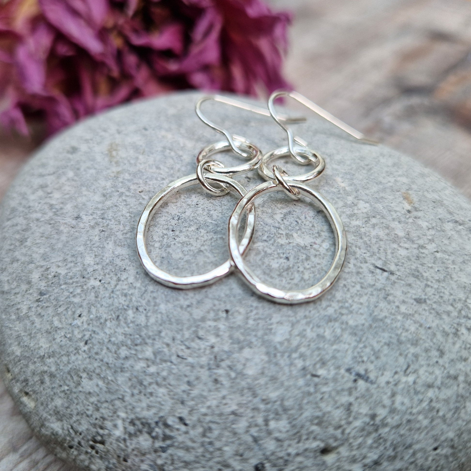 Each earring has one Sterling Silver open circle suspended from silver earring wire. A hammered texture silver open oval hangs from the open circle via a small circle link.