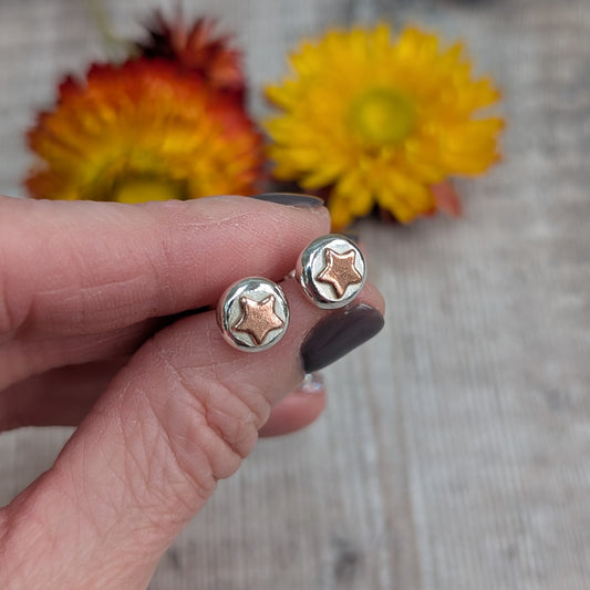 Stud Earrings in Hand
A pair of recycled sterling silver and copper star stud earrings held in a hand, showcasing their small, organic shape. Each silver pebble is formed by melting scrap silver, with a contrasting copper star. Sustainable, handmade jewellery for everyday wear.