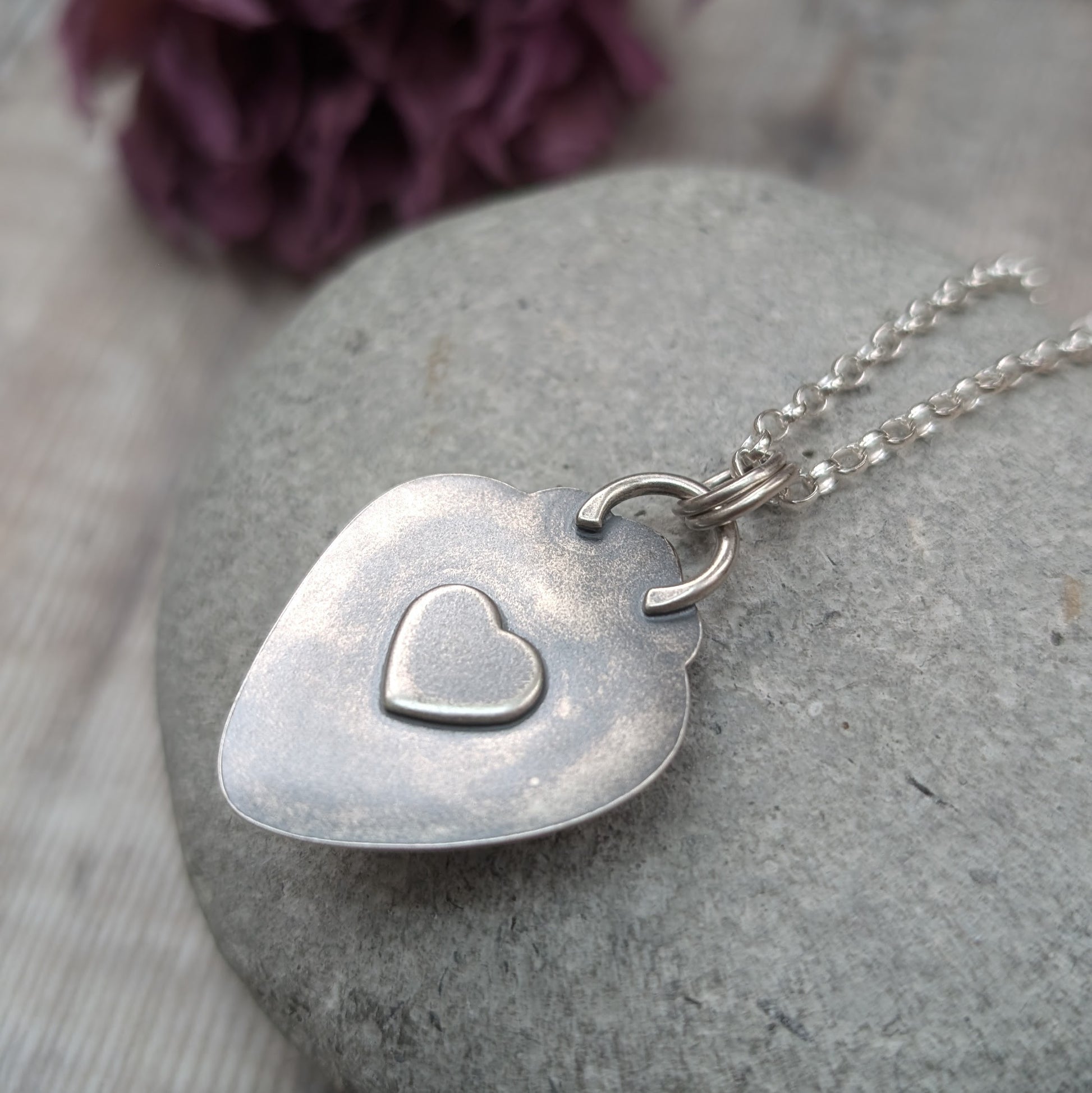 Pendant has a raised heart detail on the back.