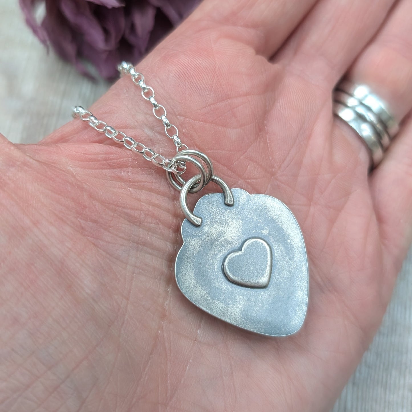 Pendant has a raised heart detail on the back.