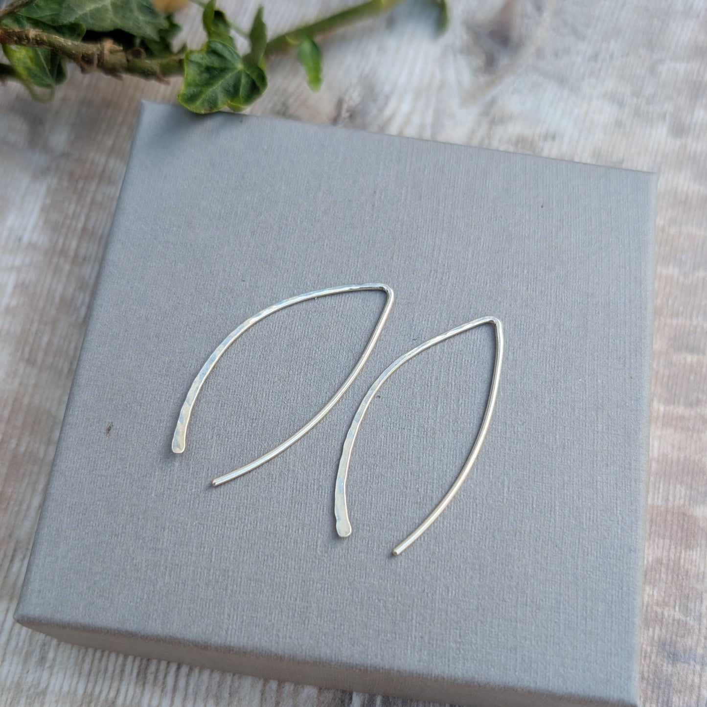 Silver Large Threader Earrings made from recycled sterling silver, shown on a grey jewellery box with ivy leaves in the background.