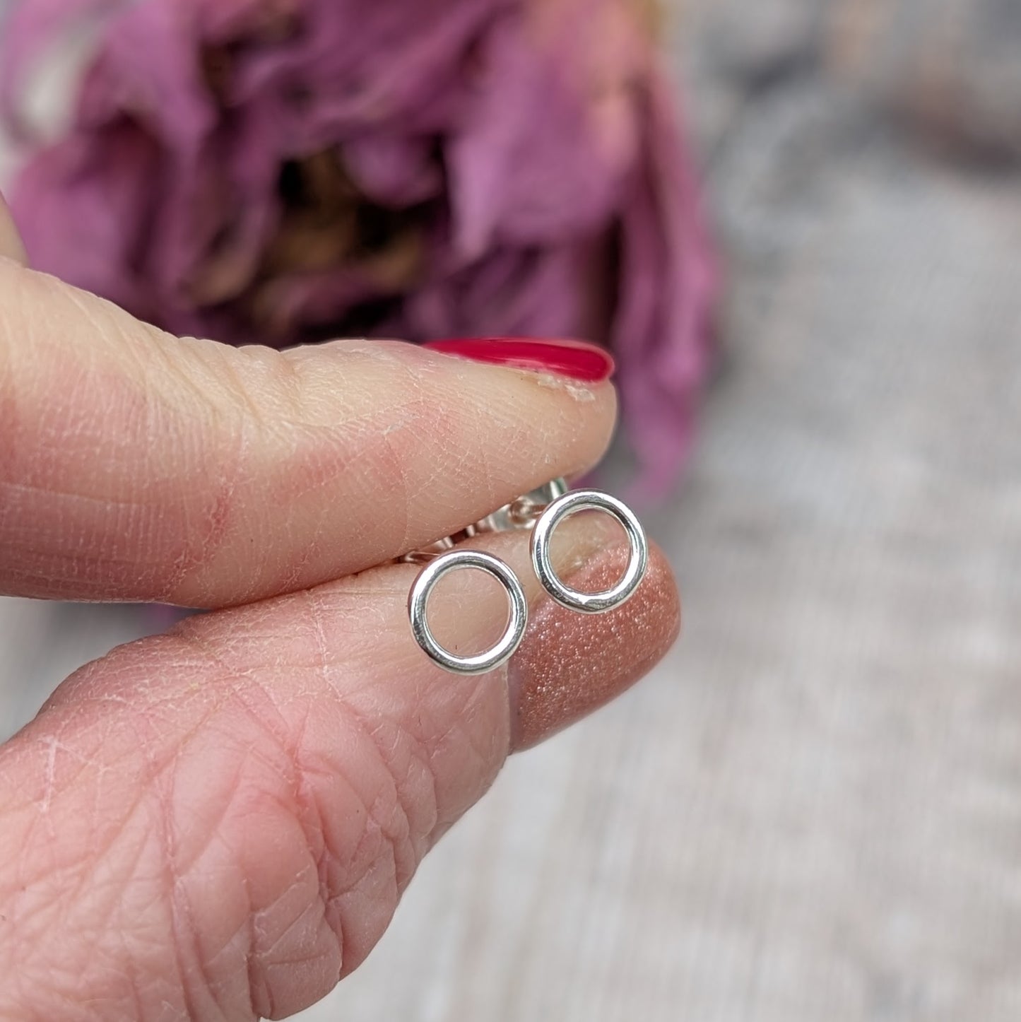 Each earring is a 6mm wide Sterling Silver smooth open circle attached to silver stud bar.