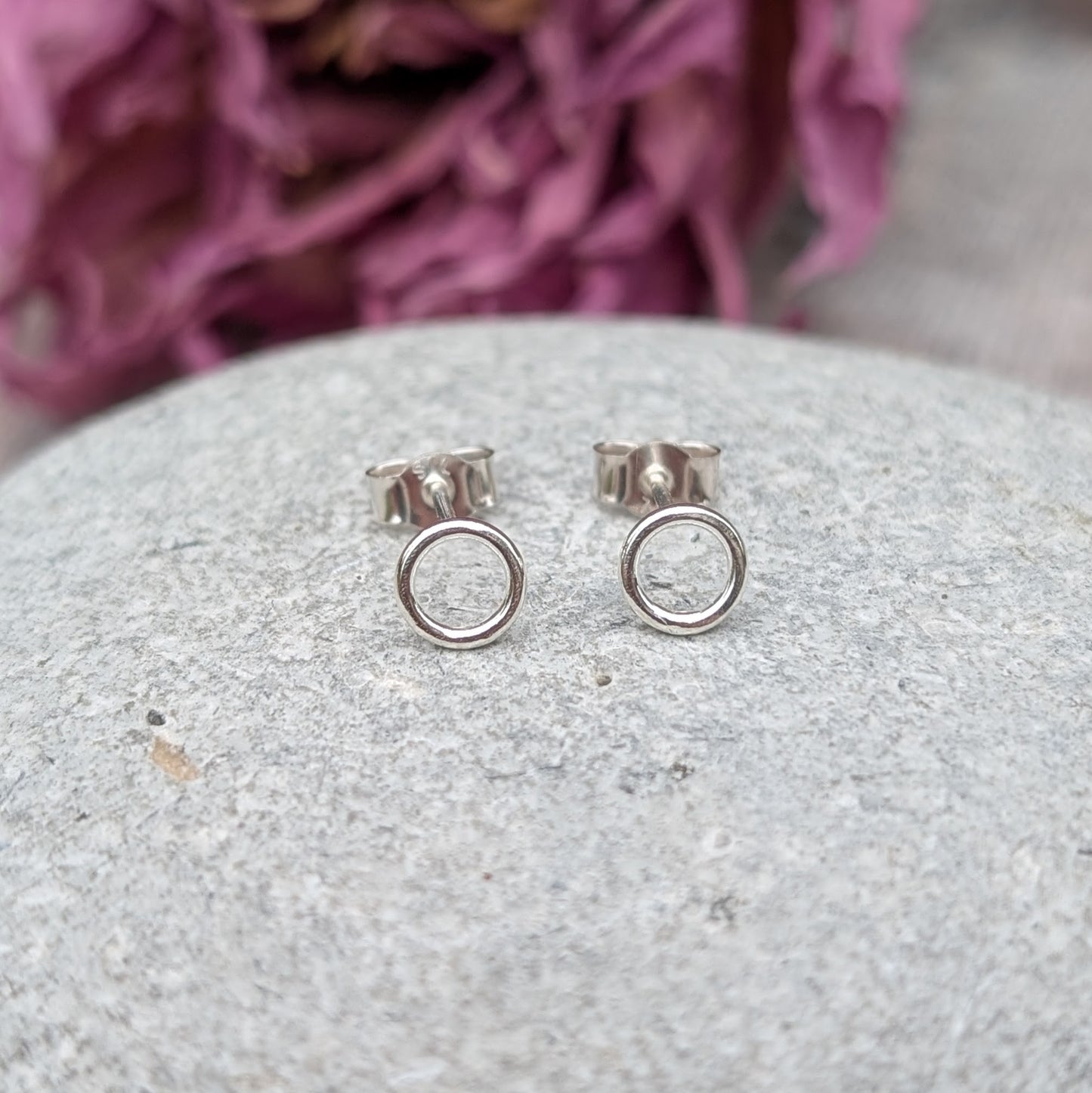Each earring is a 6mm wide Sterling Silver smooth open circle attached to silver stud bar.