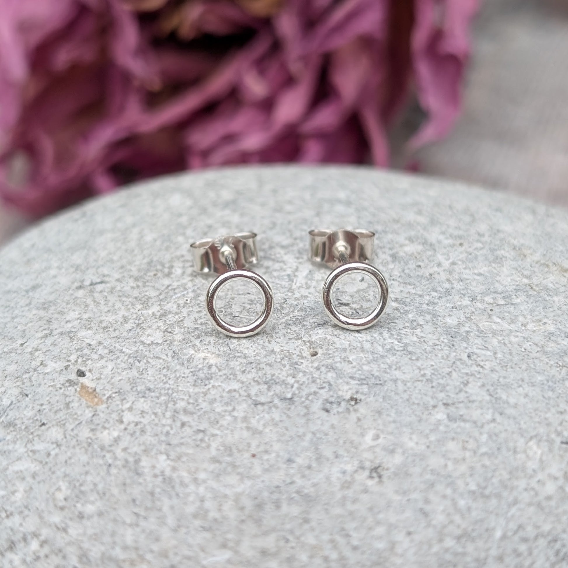 Each earring is a 6mm wide Sterling Silver smooth open circle attached to silver stud bar.