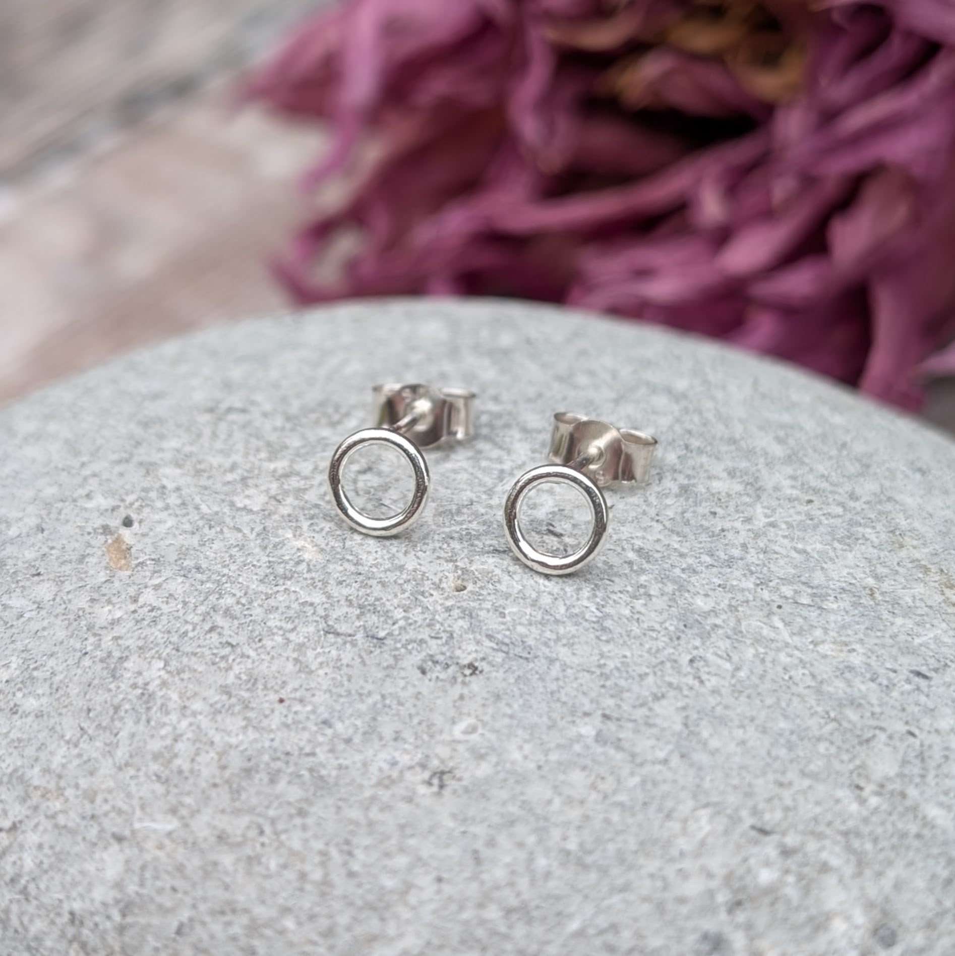 Each earring is a 6mm wide Sterling Silver smooth open circle attached to silver stud bar.