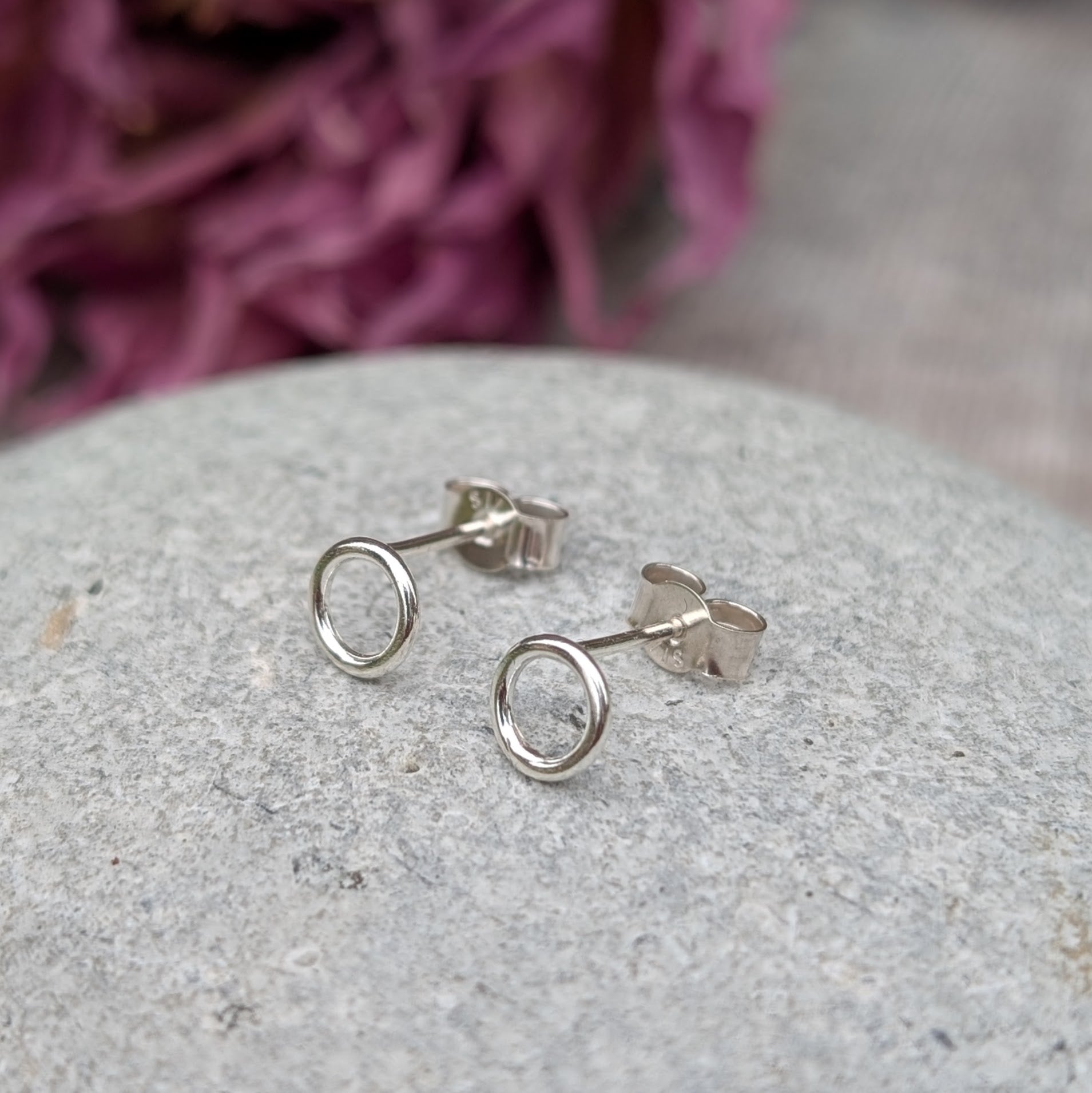 Each earring is a 6mm wide Sterling Silver smooth open circle attached to silver stud bar.