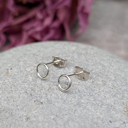Each earring is a 6mm wide Sterling Silver smooth open circle attached to silver stud bar.