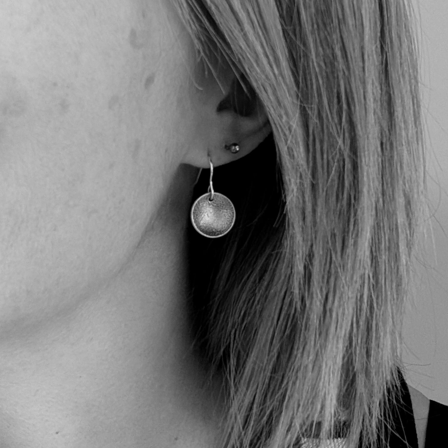 Silver Textured Dome Disc Earrings shown being worn.
