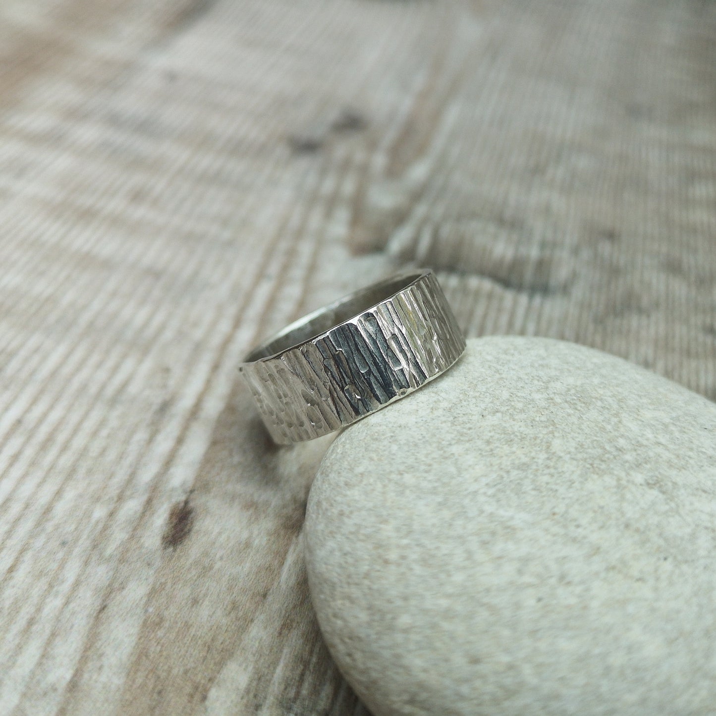 Wide Sterling Silver ring with bark like texture finish.