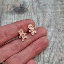 Load image into Gallery viewer, Copper gingerbread man shaped stud earrings set on sterling silver bars. Gingerbread man shape measures approximately 8mm x 12mm with hammered texture and two button indentations.