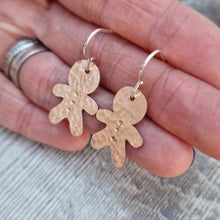 Load image into Gallery viewer, Copper gingerbread man shaped drop earrings set on sterling silver ear wires, drops approximately 30mm. Gingerbread man shape measures approximately 20mm with hammered texture and three button indentations.