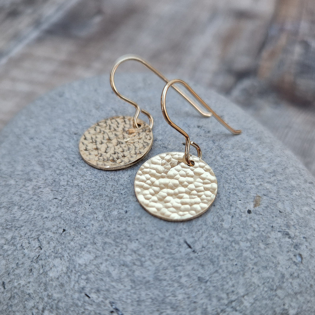 Gold hammered disc drop earrings. Each earring has one gold filled disc with hammered texture dropping from gold earring wire. Disc measuring approximately 15mm diameter. 