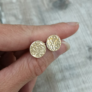 9ct gold hammered disc stud earrings. Each earring has one gold disc with hammered texture mounted on gold bar. Disc measuring approximately 8mm, 10mm or 12mm in diameter.