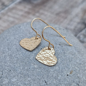 Gold hammered heart shaped drop earrings. Each earring has one gold filled solid heart with hammered texture dropping from gold earring wire. Heart measuring approximately 15mm diameter.