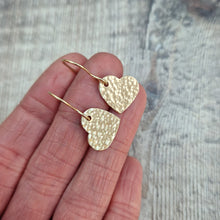 Load image into Gallery viewer, Gold hammered heart shaped drop earrings. Each earring has one gold filled solid heart with hammered texture dropping from gold earring wire. Heart measuring approximately 15mm diameter.
