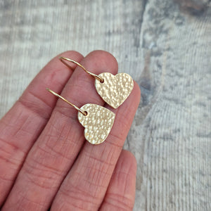 Gold hammered heart shaped drop earrings. Each earring has one gold filled solid heart with hammered texture dropping from gold earring wire. Heart measuring approximately 15mm diameter.