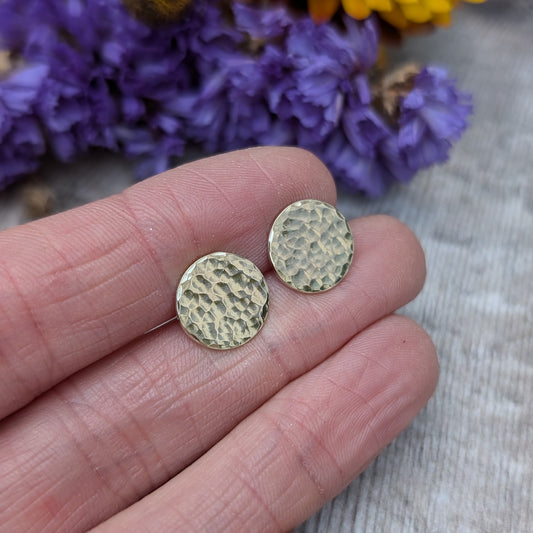 9ct gold hammered disc stud earrings. Each earring has one gold disc with hammered texture mounted on gold bar. Disc measuring approximately 8mm, 10mm or 12mm in diameter.