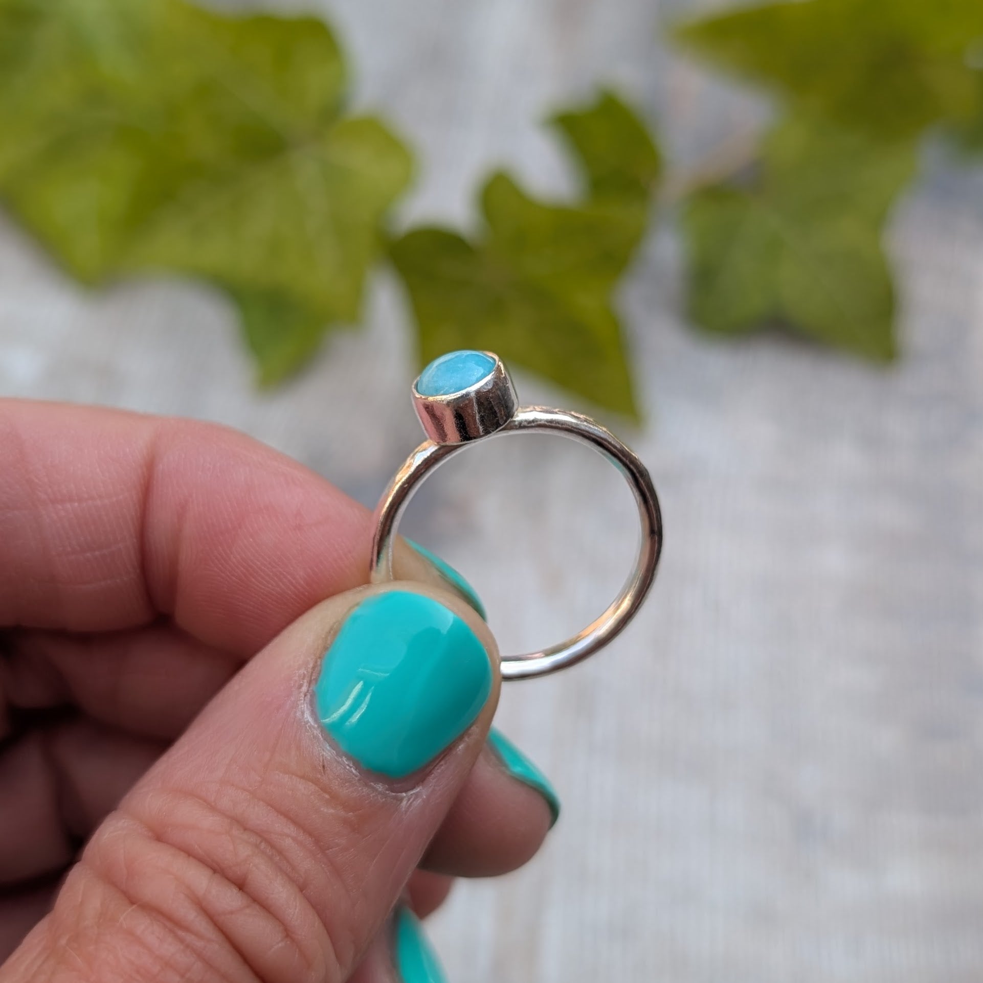 Side view of amazonite ring size R showing the handmade recycled Sterling Silver band and raised bezel setting holding the round Amazonite stone.