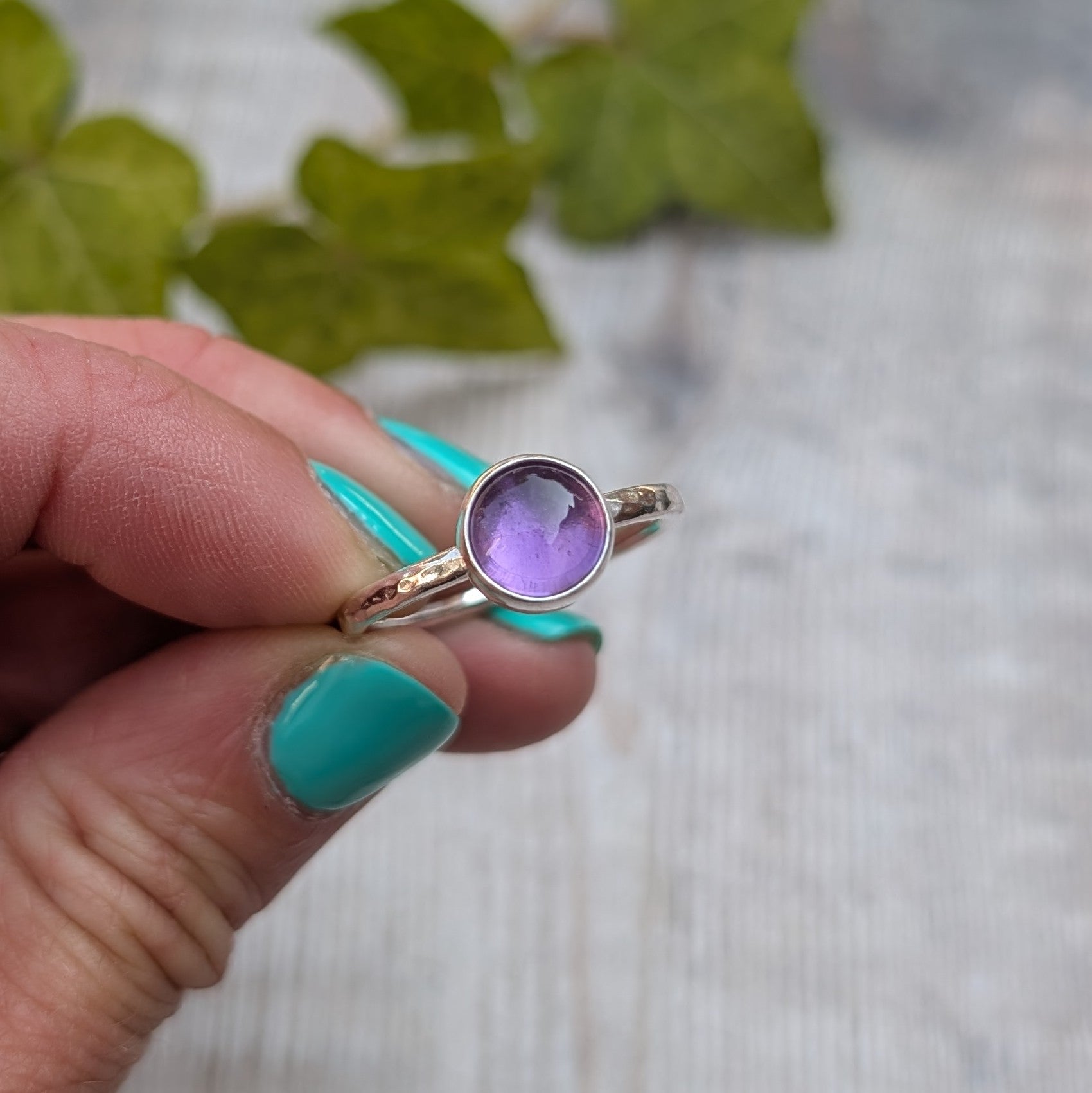 Amethyst ring size S handmade from recycled Sterling Silver, front view highlighting the round bezel set purple Amethyst and polished silver band.