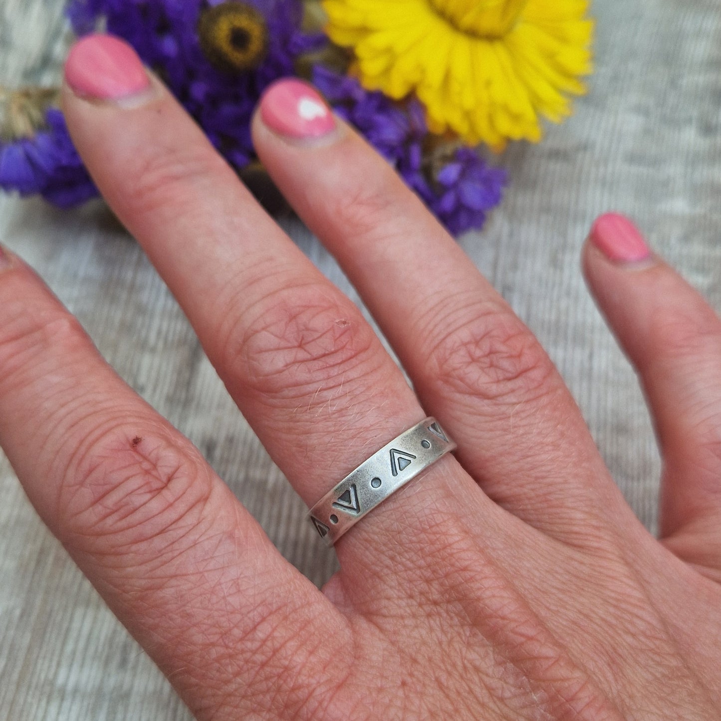 Oxidised Sterling Silver band approx. 5mm wide, stamped with triangular and dots geometric design all the way around.