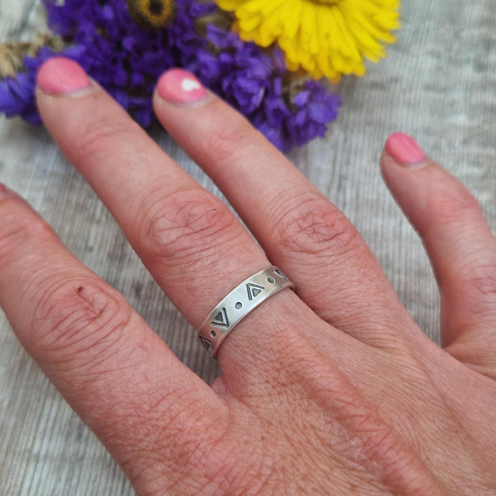 Oxidised Sterling Silver band approx. 5mm wide, stamped with triangular and dots geometric design all the way around.