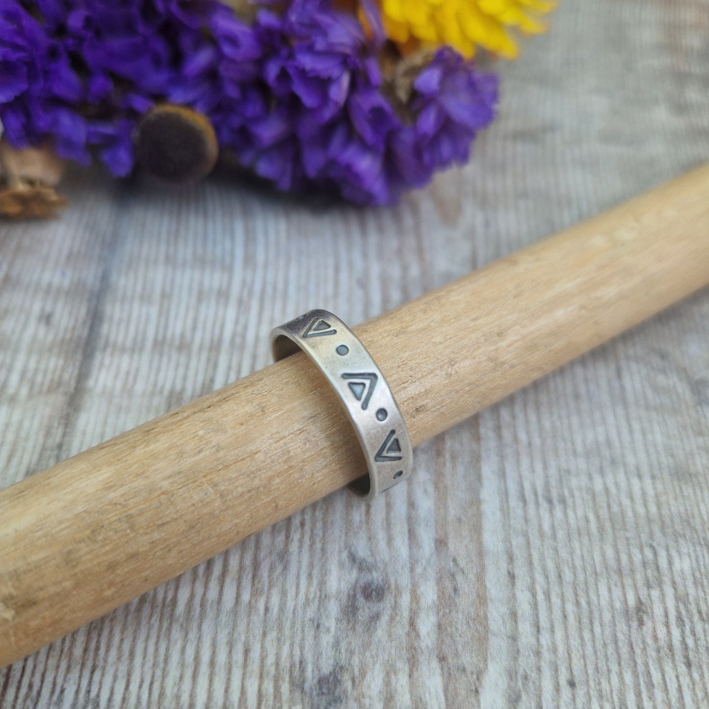 Oxidised Sterling Silver band approx. 5mm wide, stamped with triangular and dots geometric design all the way around.