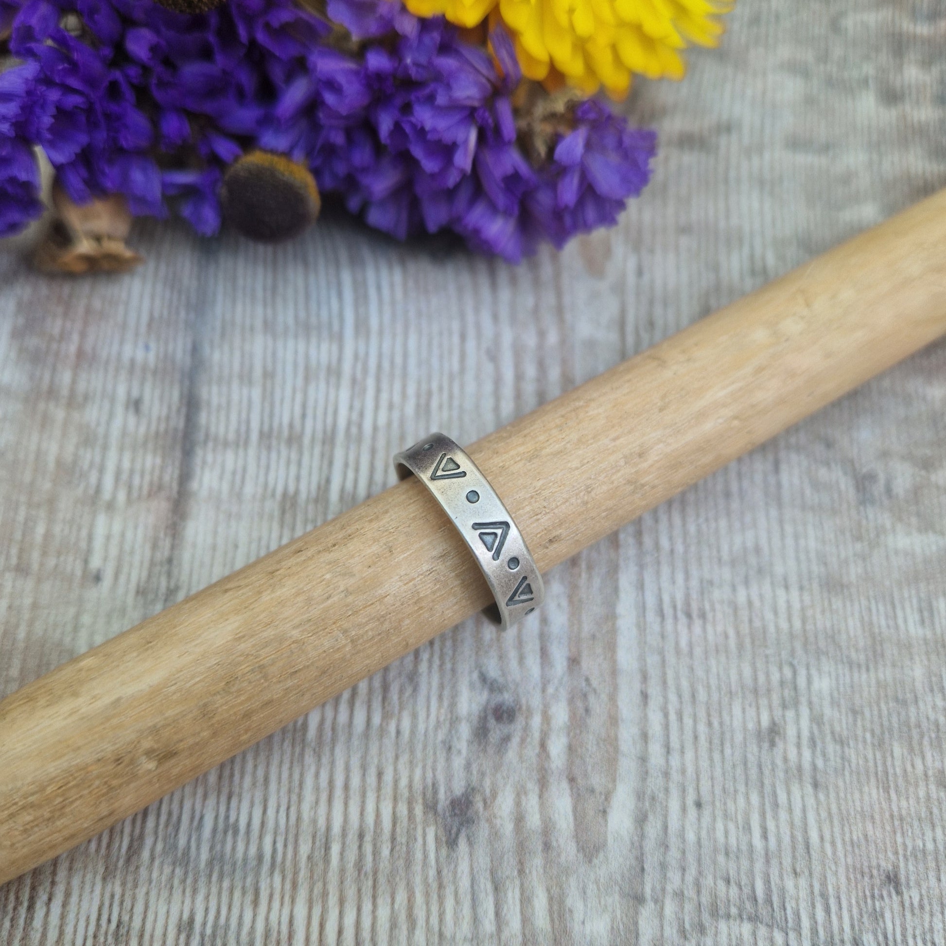 Oxidised Sterling Silver band approx. 5mm wide, stamped with triangular and dots geometric design all the way around.