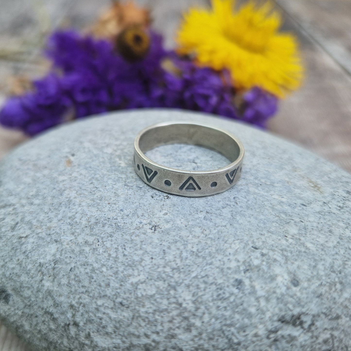 Oxidised Sterling Silver band approx. 5mm wide, stamped with triangular and dots geometric design all the way around.