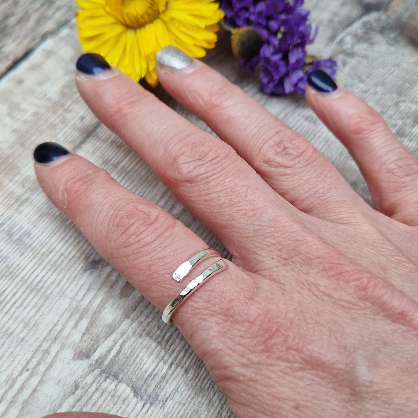 Sterling Silver hammered texture ring that wraps around the finger and overlaps.