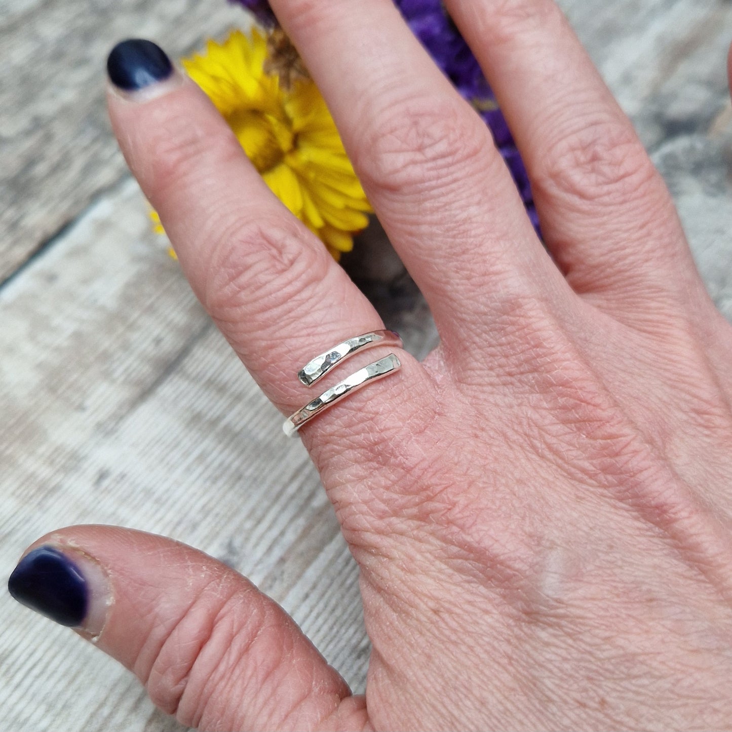 Sterling Silver hammered texture ring that wraps around the finger and overlaps.