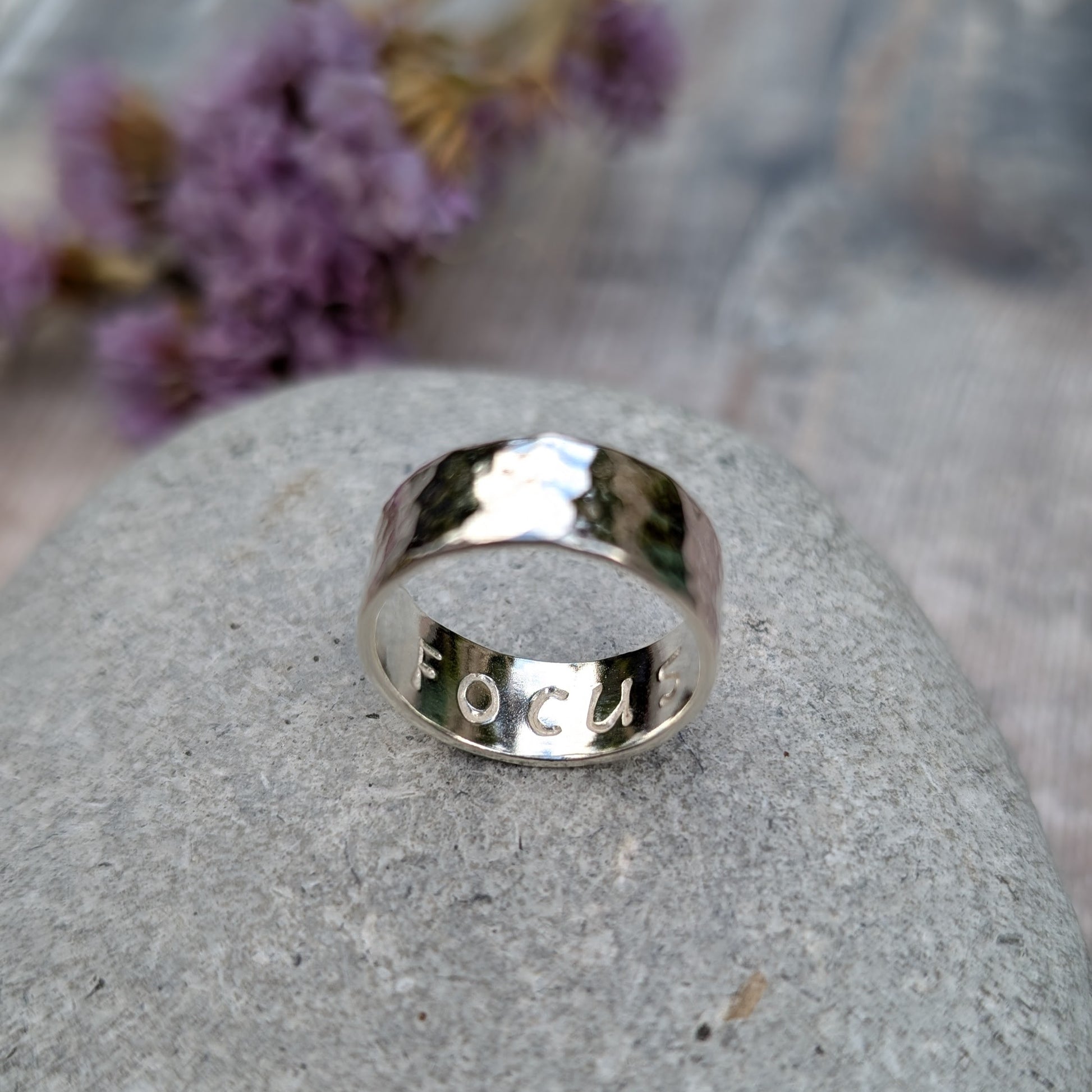 Sterling silver wide ring band with hammered texture finish and high polish. F O C U S stamped on the inside of the band.