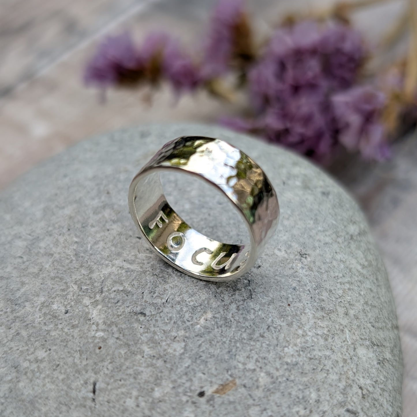 Sterling silver wide ring band with hammered texture finish and high polish. F O C U S stamped on the inside of the band.