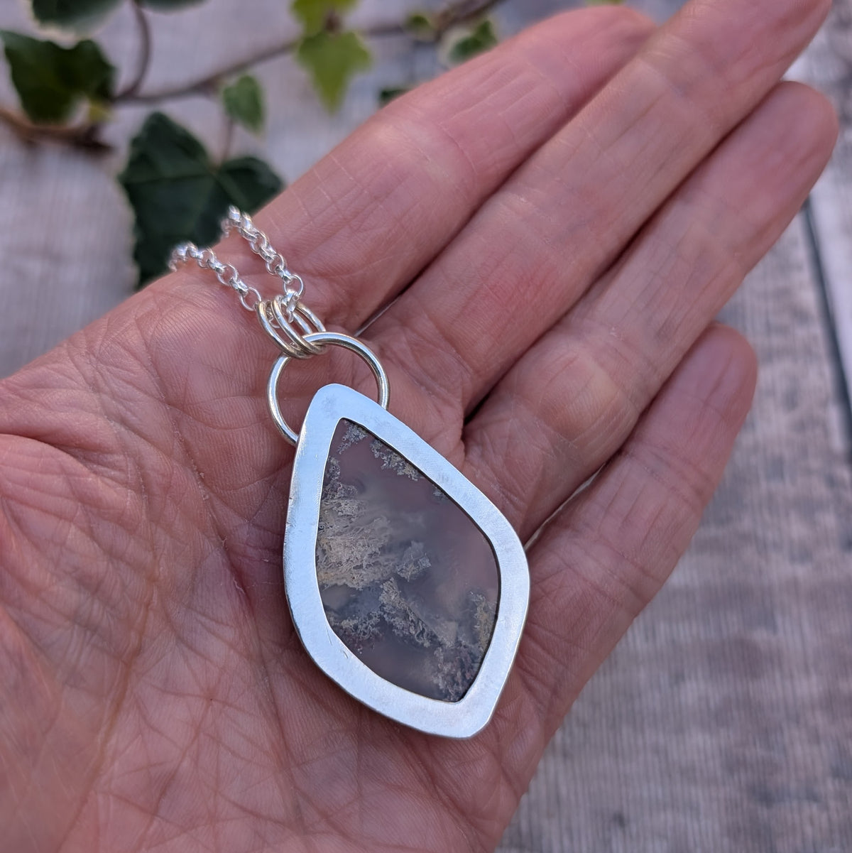 Back of Garden Moss Agate Statement Gemstone Necklace showing the handmade recycled sterling silver backing with an open centre revealing the natural patterns of the gemstone