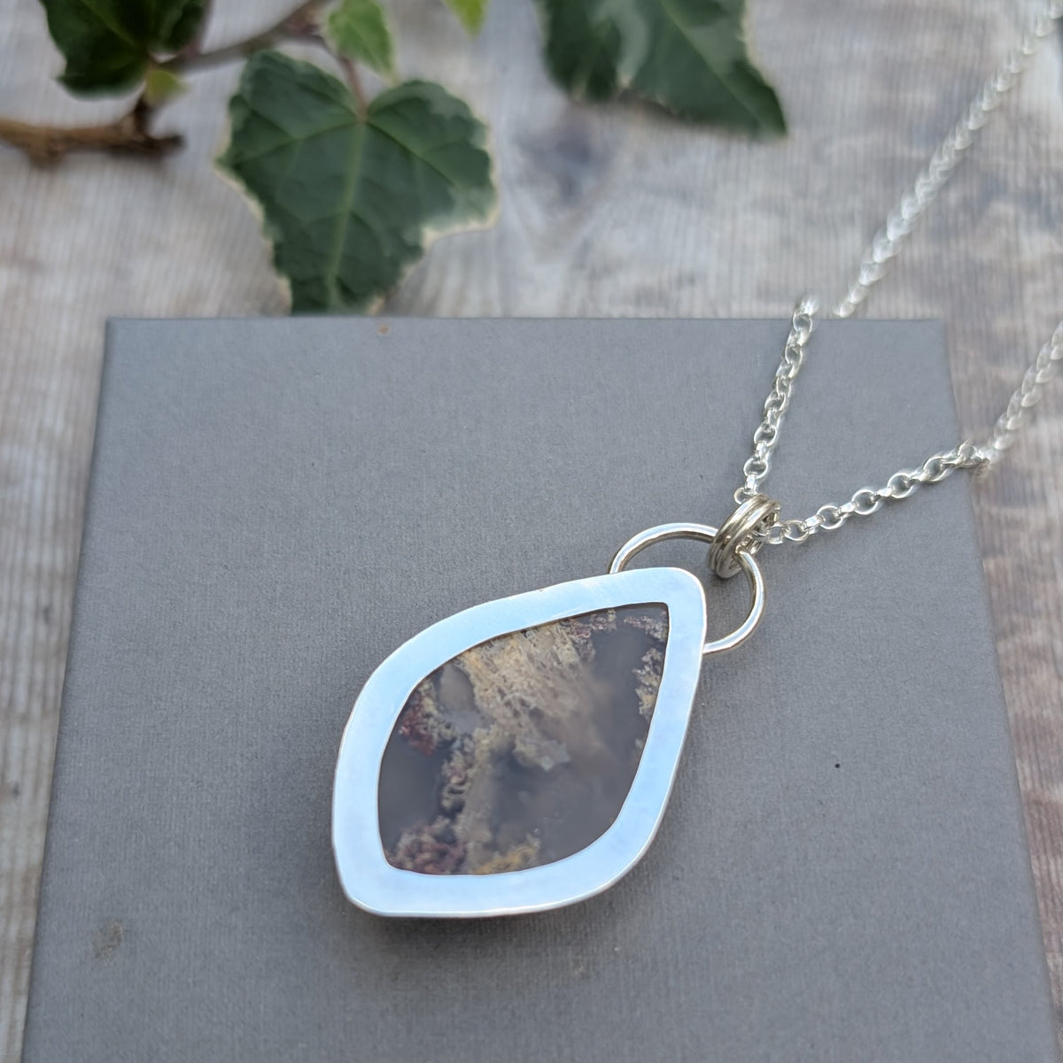 Reverse of Garden Moss Agate Statement Gemstone Necklace showing the smooth recycled sterling silver backing, open centre and circular silver links connecting the pendant to the chain.