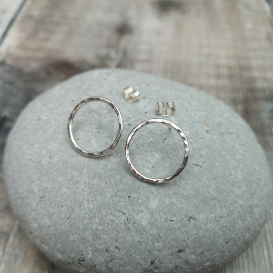 Each earring is a Sterling Silver open circle with hammered finish attached to a silver stud bar.