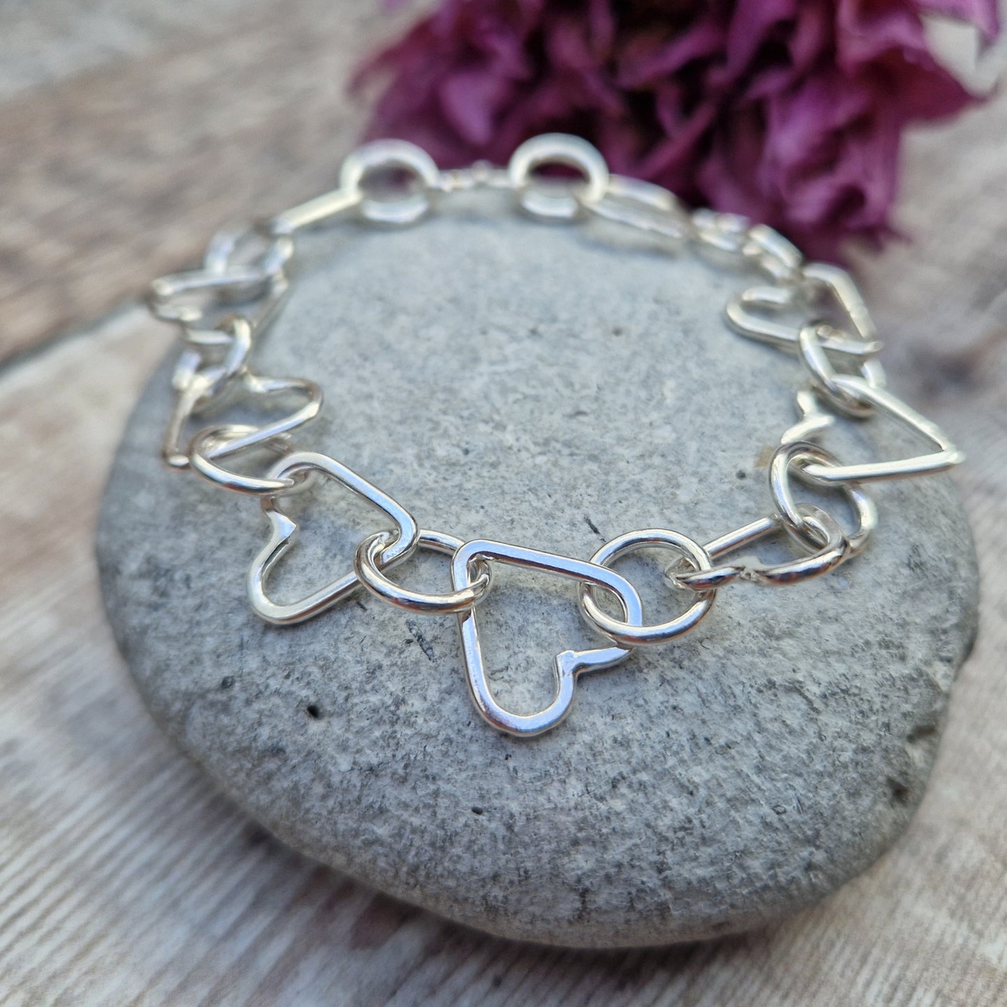 Sterling Silver interlinking hearts bracelet. Each open heart is linked with an open circle, nine hearts and 10 circles in total repeating pattern with ‘S’ link.