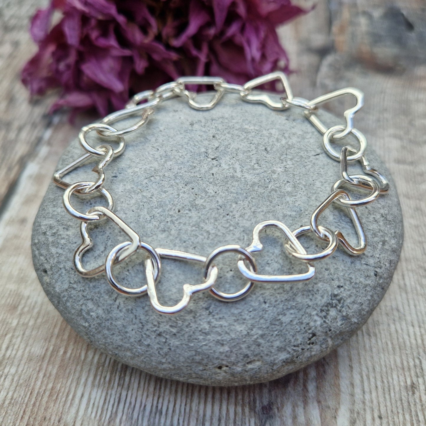 Sterling Silver interlinking hearts bracelet. Each open heart is linked with an open circle, nine hearts and 10 circles in total repeating pattern with ‘S’ link.